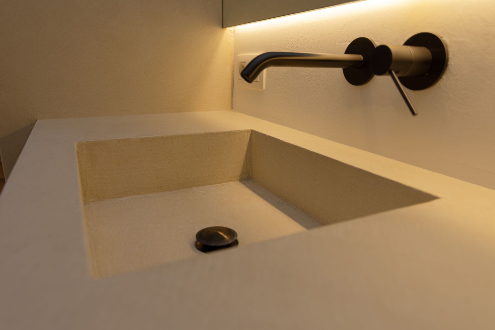 Stijlvoorbeeld ingebouwde microcement wastafel warme uitstraling